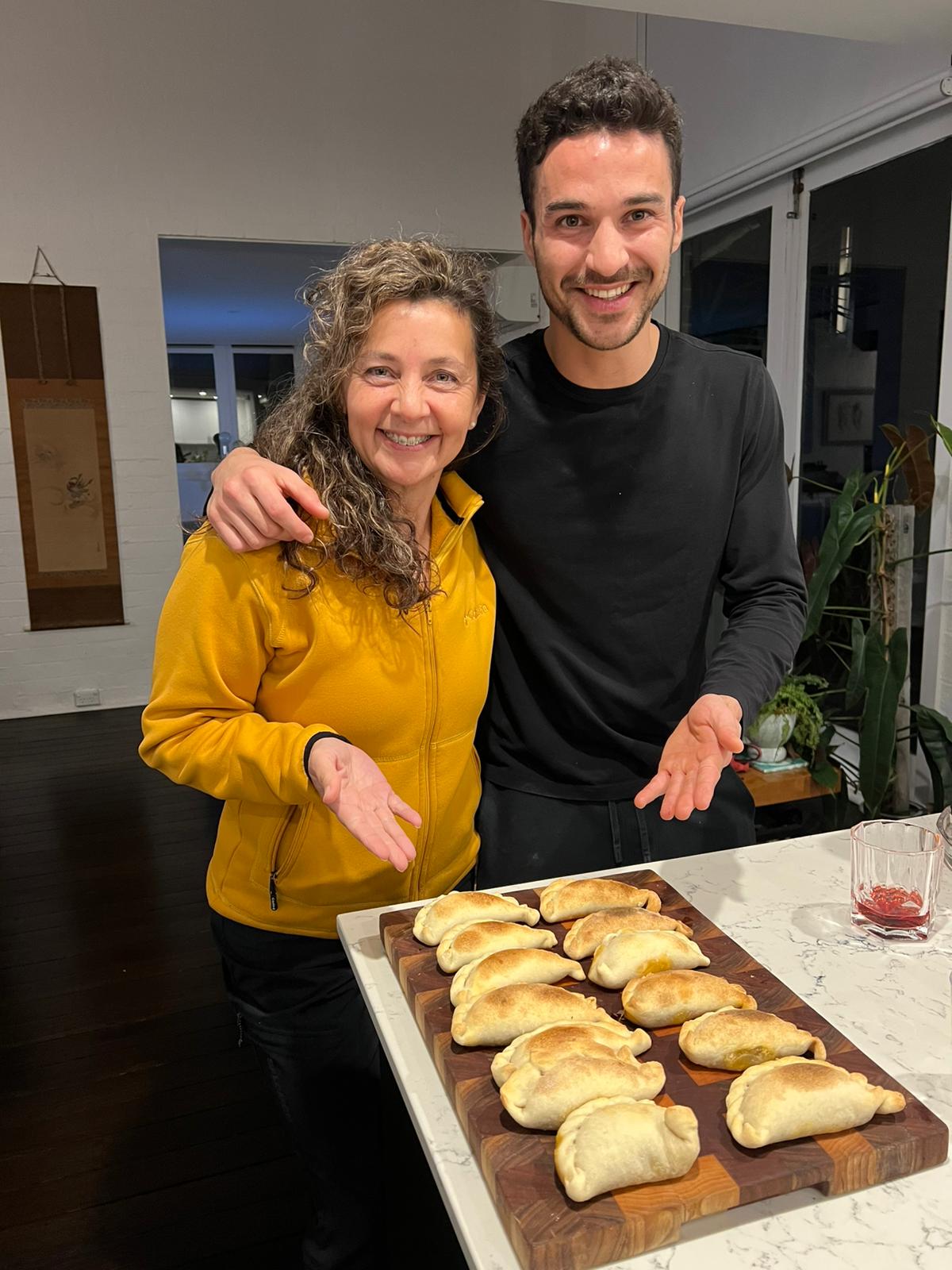 Pedro and friend's mom making handmade empanadas in Sydney, exploring the first idea of Argentum Empanadas
