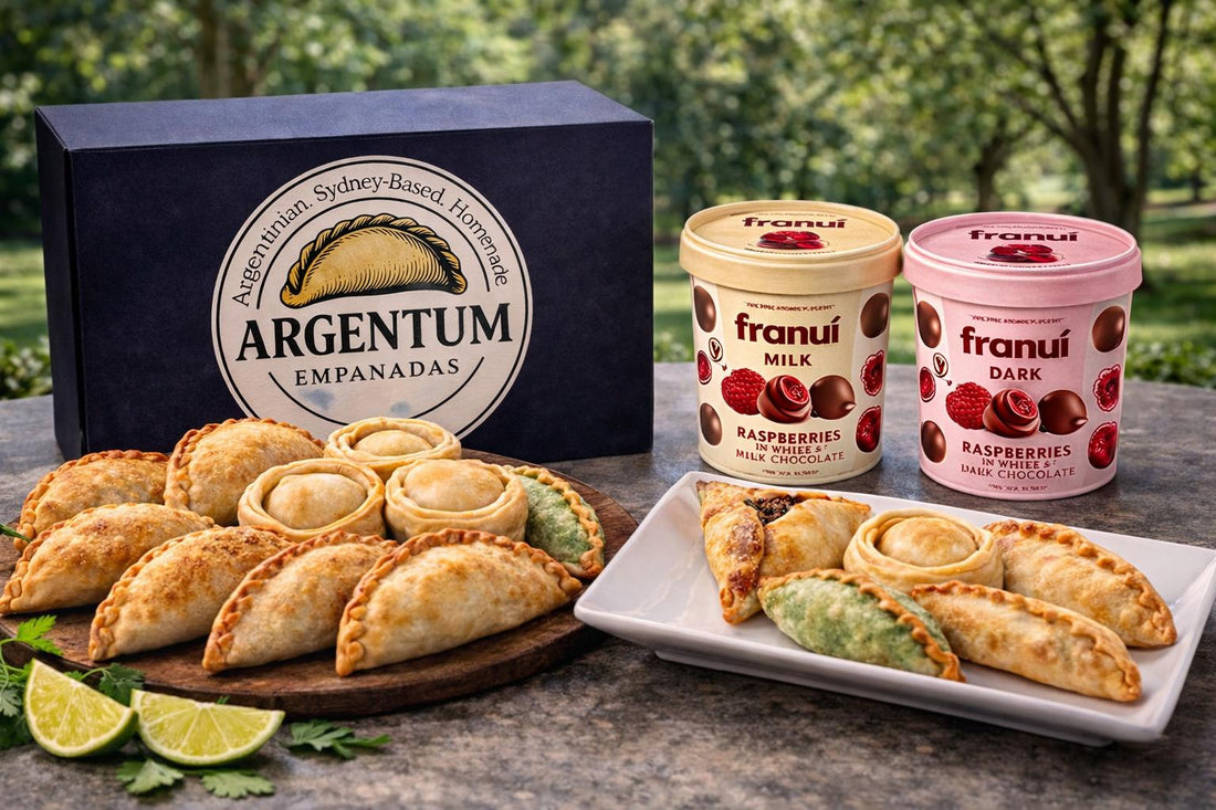 Argentum Empanadas box with assorted baked empanadas and two tubs of Franui chocolate-covered raspberries — milk and dark, styled outdoors in Sydney