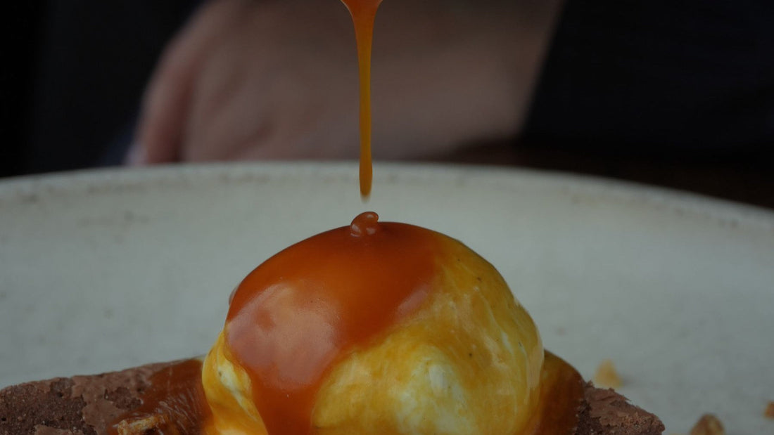 Caramel sauce is poured over a brownie and vanilla ice cream to illustrate dulce de leche dessert ideas.