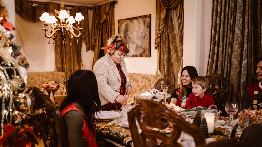 Family and friends gather around a warmly decorated Christmas dinner table at home.