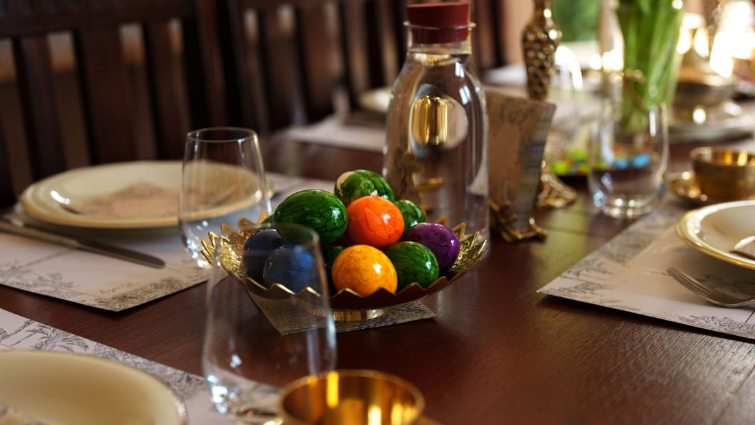 Colourful painted eggs form the centrepiece of an elegantly set Easter dining table.