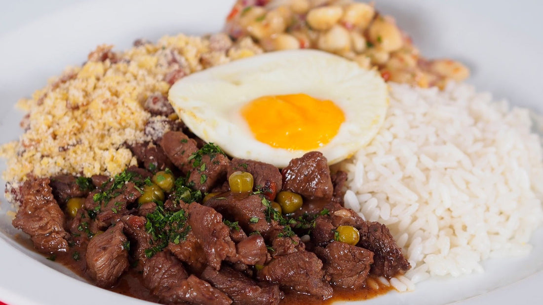A Brazilian feijoada-style meal is served with rice, farofa, beans and a fried egg.
