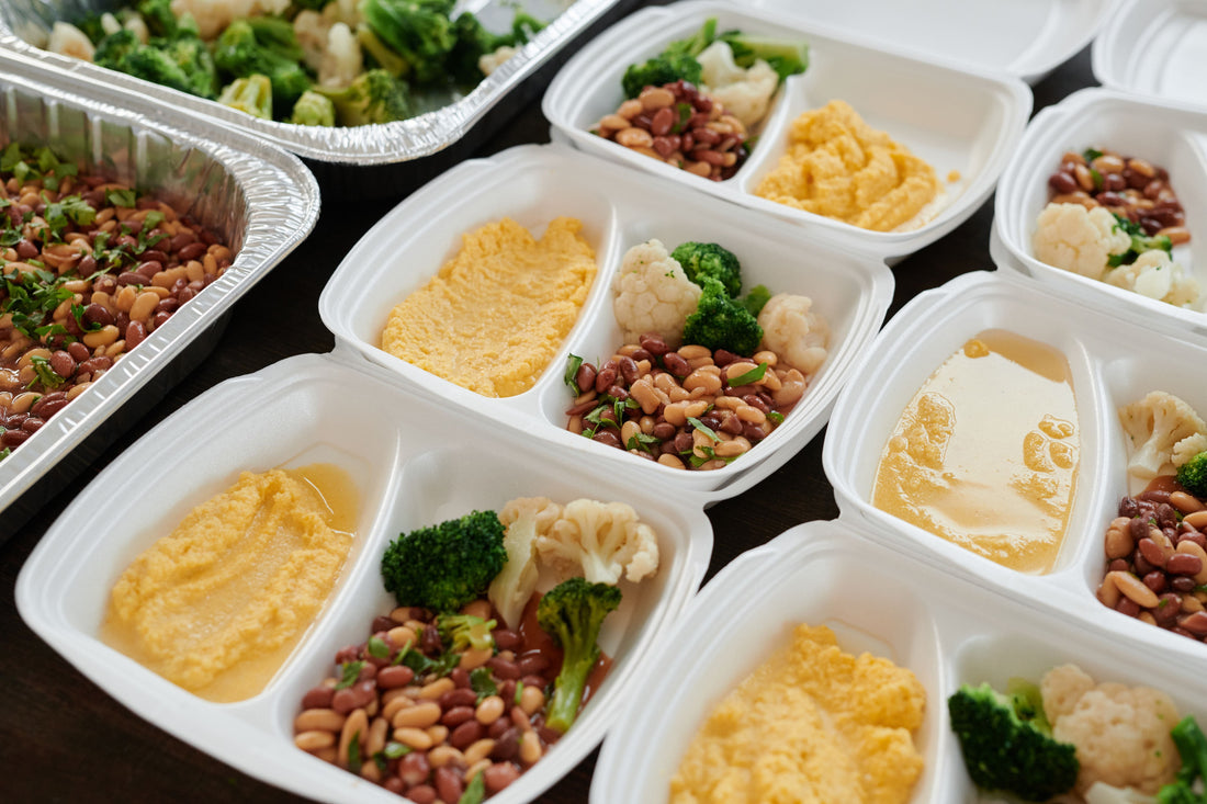 Assorted prepared meals portioned into containers for a fortnightly freezer plan.