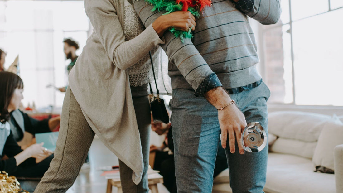 Colleagues celebrate together at a bright office Christmas party.
