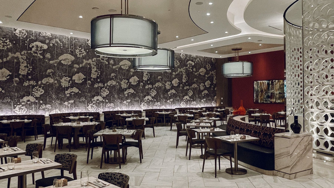 A polished contemporary restaurant dining room is arranged for evening steakhouse service.