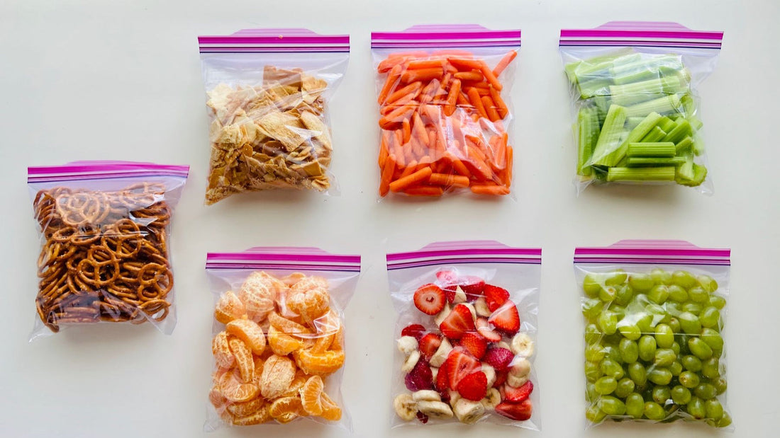 Portioned snacks and produce are sealed in clear storage bags to illustrate organised freezer preparation.