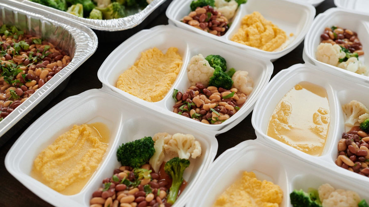 Prepared meals with beans, vegetables and mash are portioned into containers for convenient freezer storage.