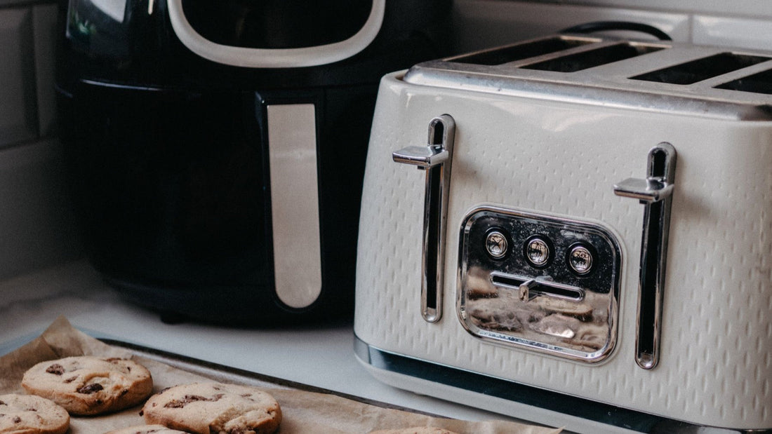 An air fryer, toaster and lined baking tray show practical countertop options for reheating food.