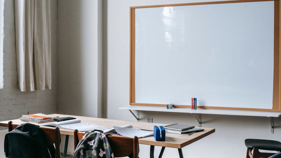 Study books, worksheets and stationery are arranged in a bright language classroom.