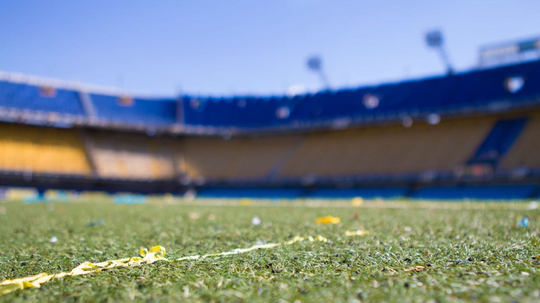 The pitch and blue-and-yellow stands of La Bombonera football stadium in Buenos Aires.