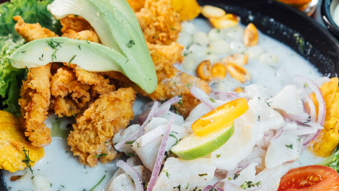 Peruvian ceviche with lime and red onion is served alongside crispy seafood and plantain.