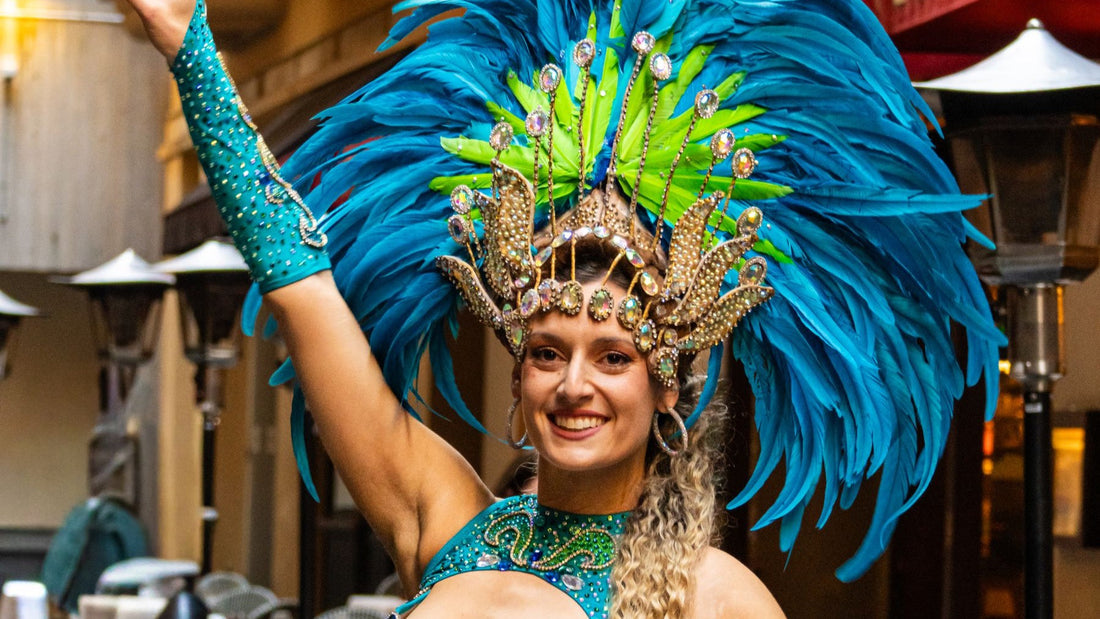 A carnival dancer in a blue feathered costume performs during a colourful Sydney street festival.
