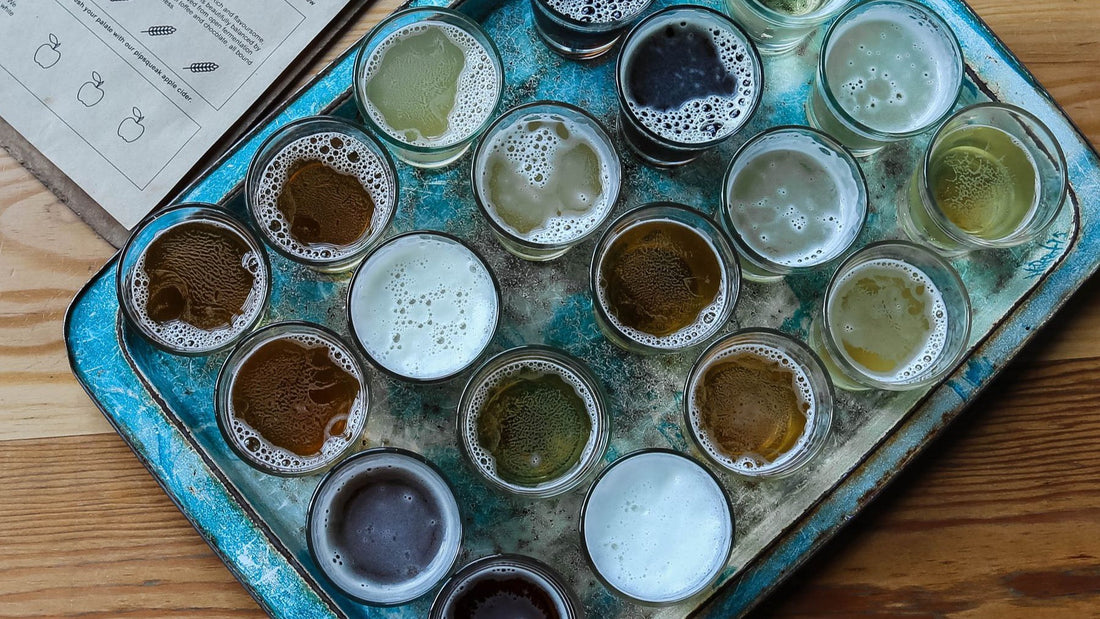 A tasting tray holds a varied selection of light, amber and dark craft beers.