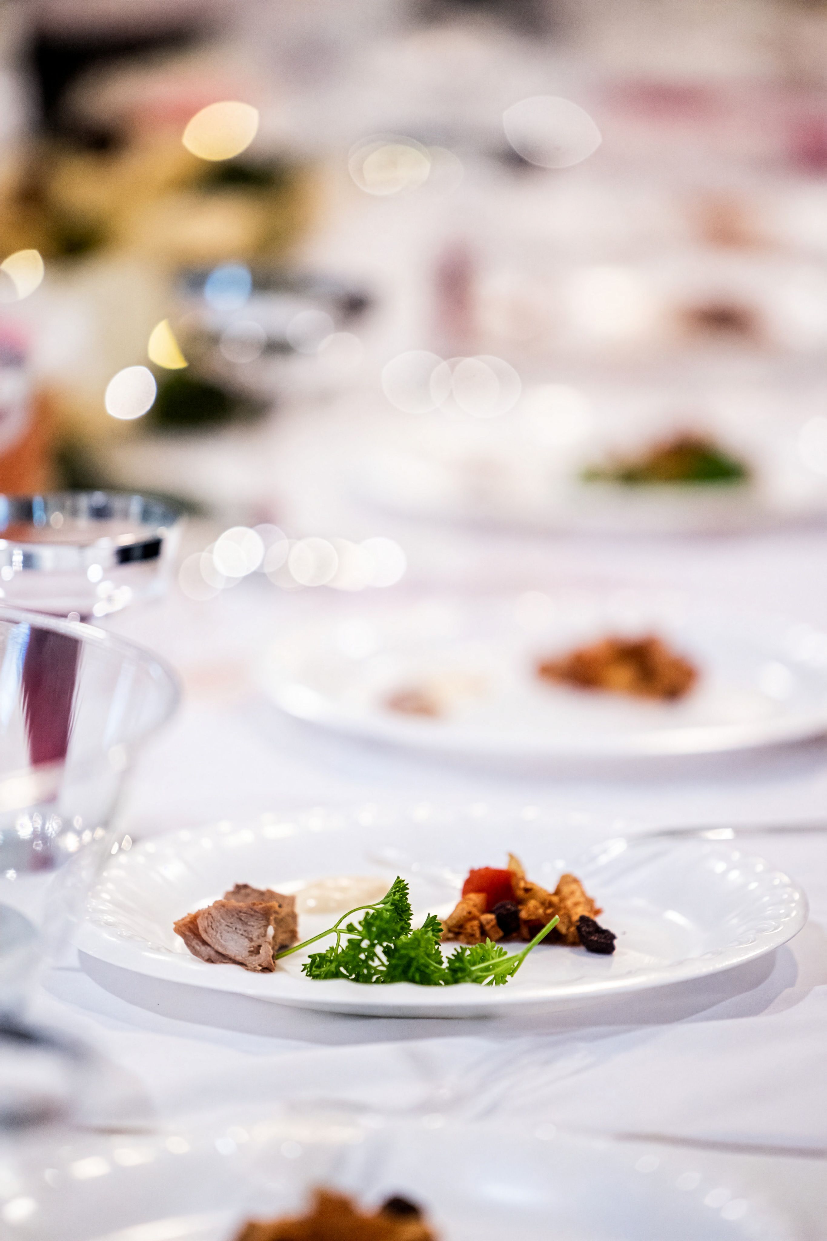 A carefully plated gourmet dish is served on an elegant restaurant table.
