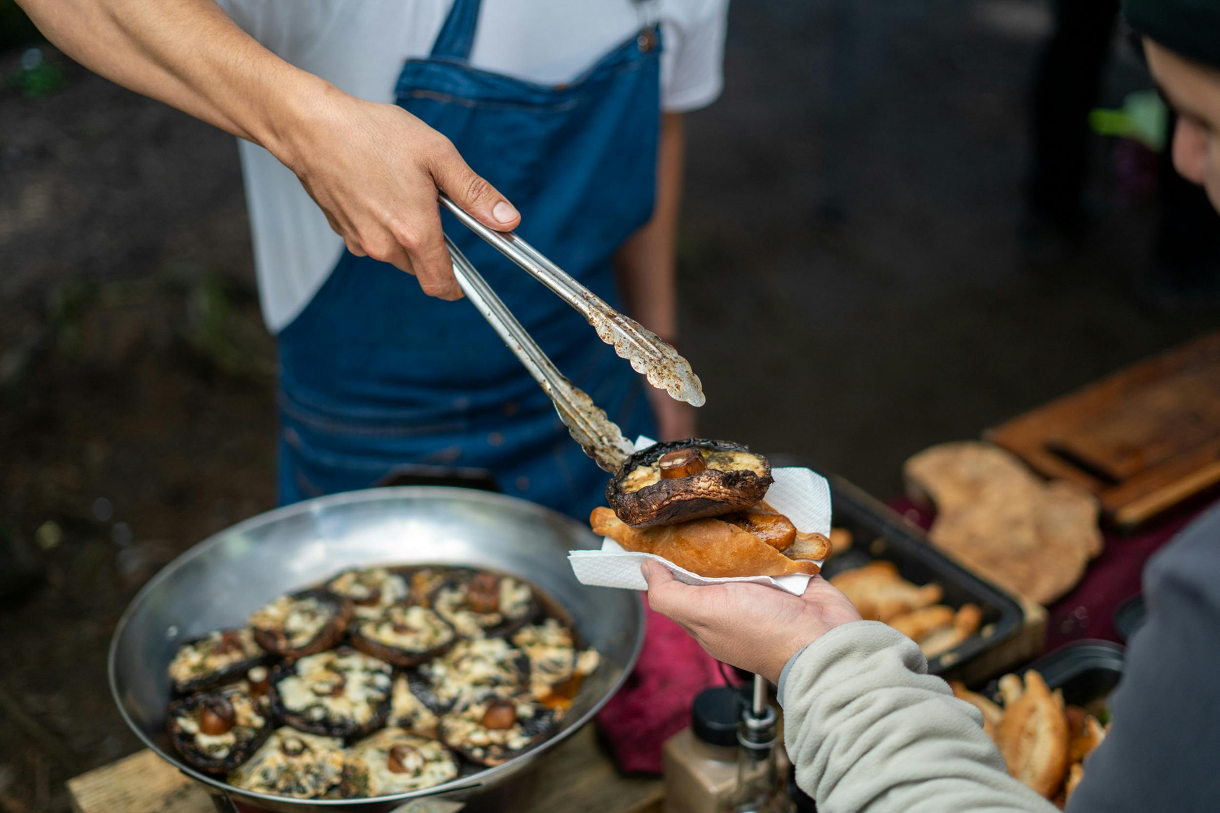 Assortment of handheld party foods including pastries and savoury finger food arranged on a table for a social event.