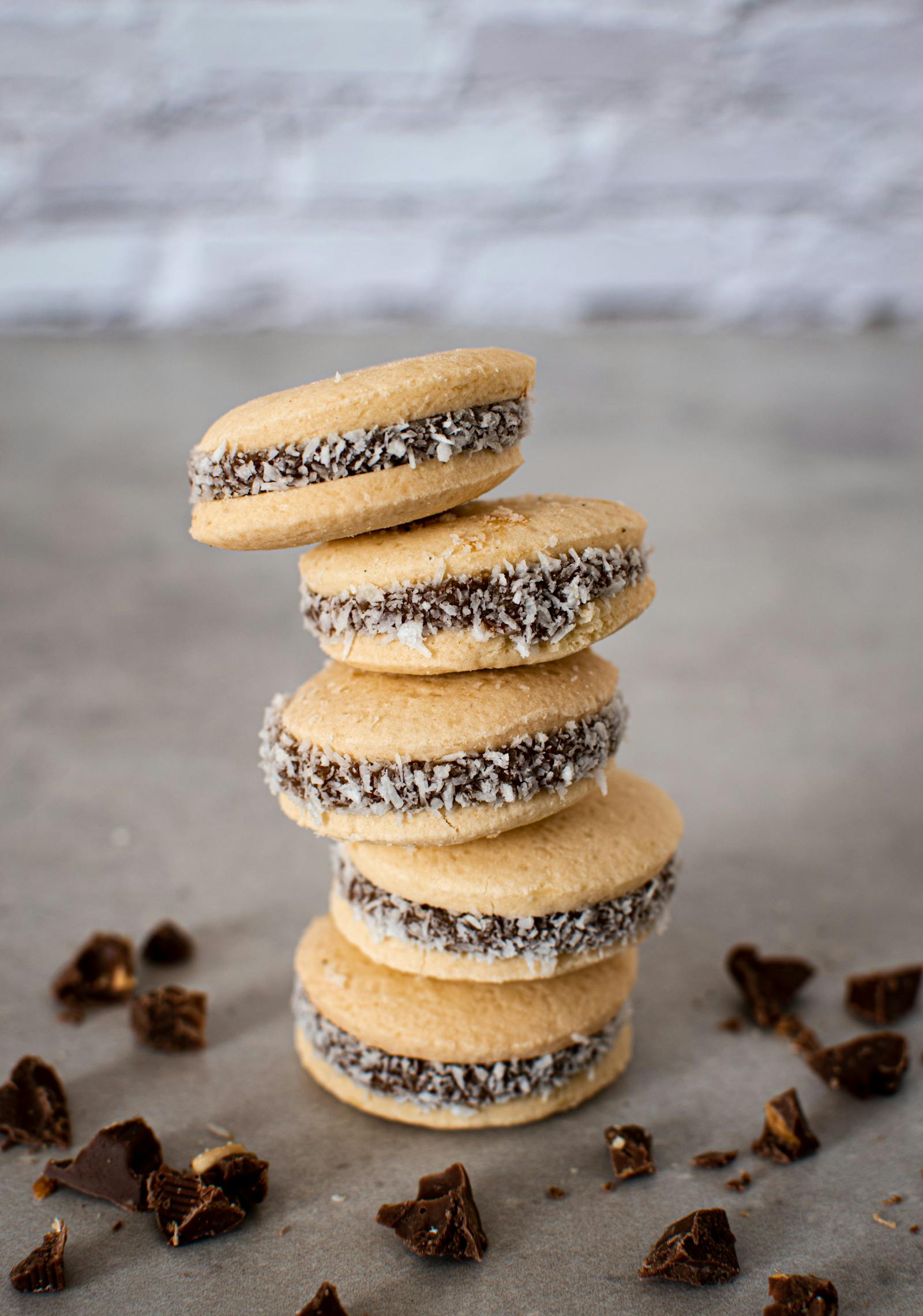 Stack of traditional Argentinian alfajores filled with dulce de leche and rolled in coconut