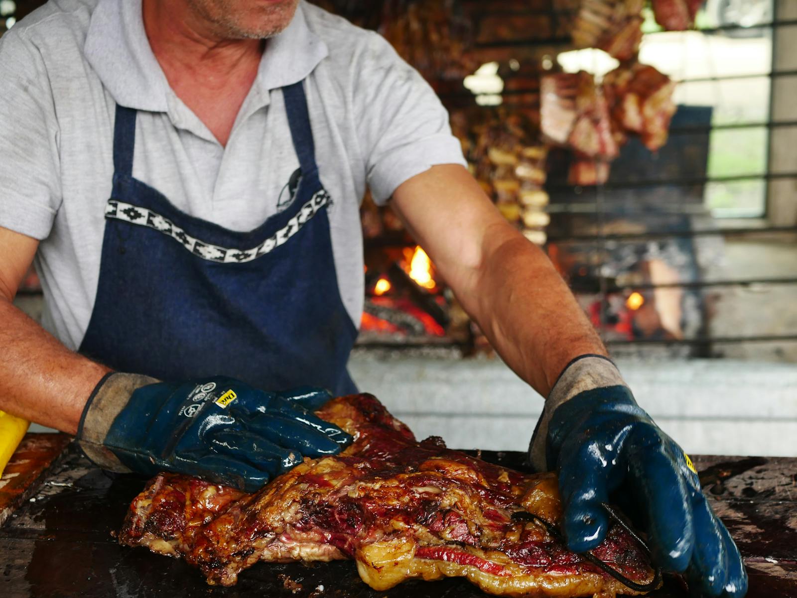Traditional Argentine asado grilling over open fire in Uribelarrea, Buenos Aires