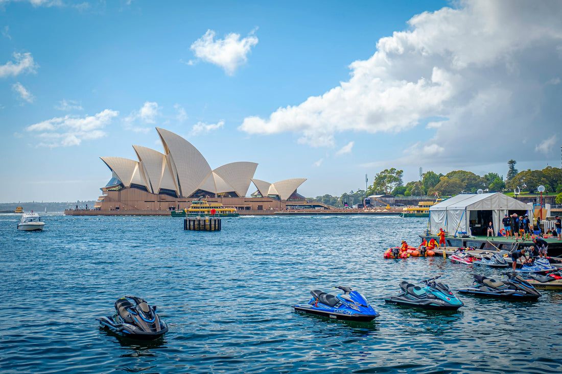 Sydney Harbour with the Opera House in the background and jet skis on the water — perfect setting for an empanada catering event in Sydney