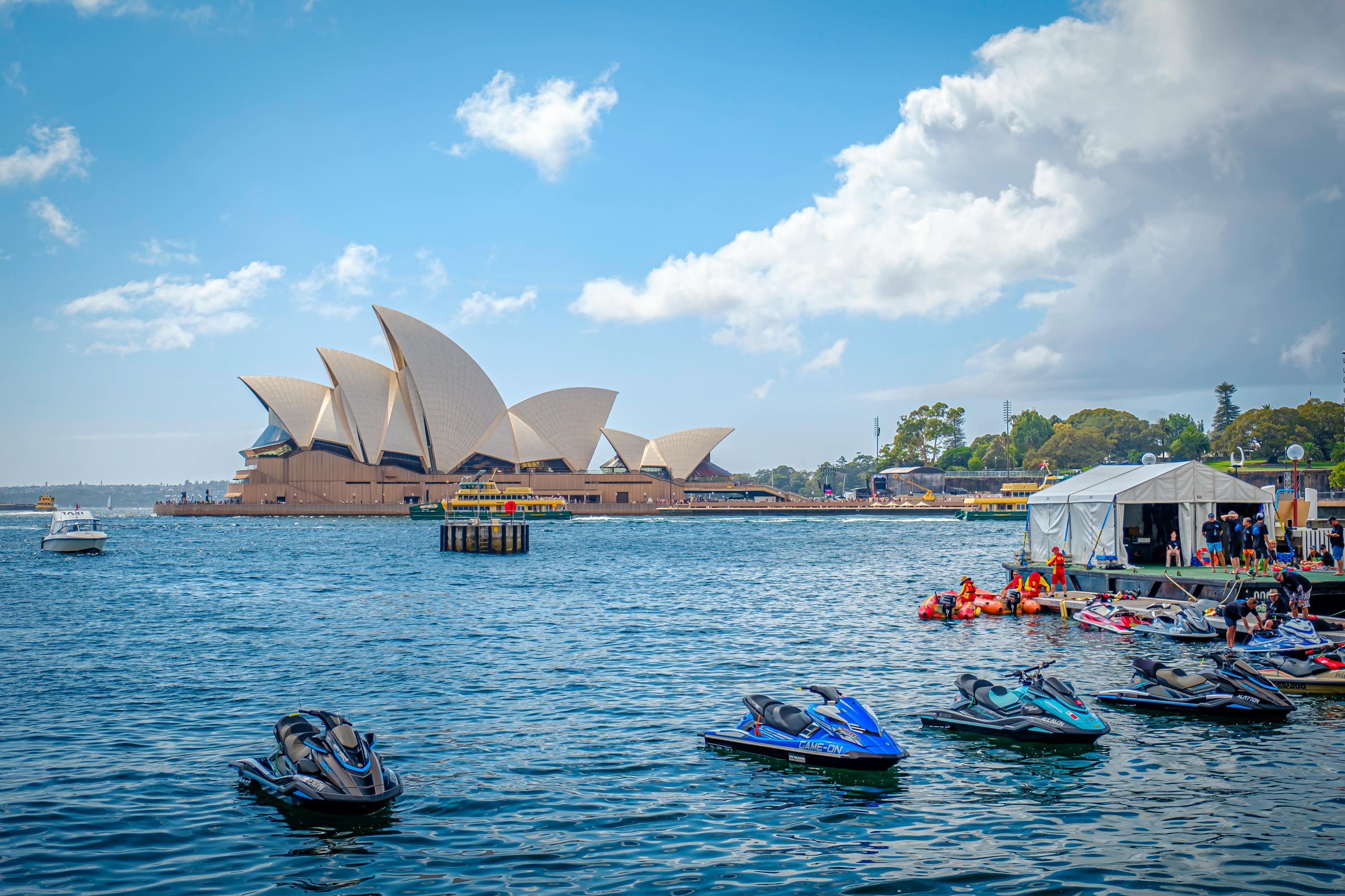 Sydney Harbour with the Opera House in the background and jet skis on the water — perfect setting for an empanada catering event in Sydney