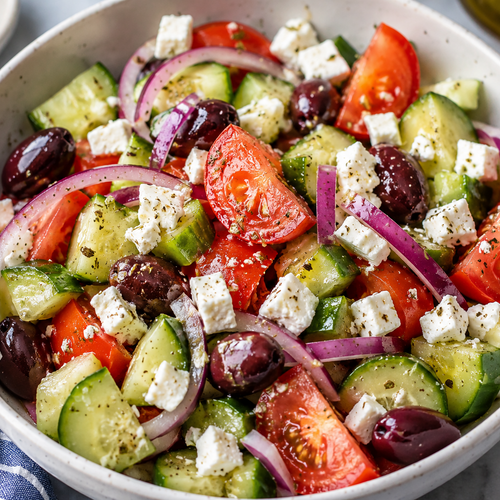 Greek salad with cucumber, tomato, red onion, Kalamata olives and feta by Argentum Empanadas