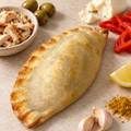 Golden Athlete empanada with chicken, green olives, mozzarella, red capsicum, lemon, garlic and curry powder.