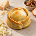 Classic empanada with overlapping golden pastry, provolone, parmesan, mozzarella and caramelised onion.